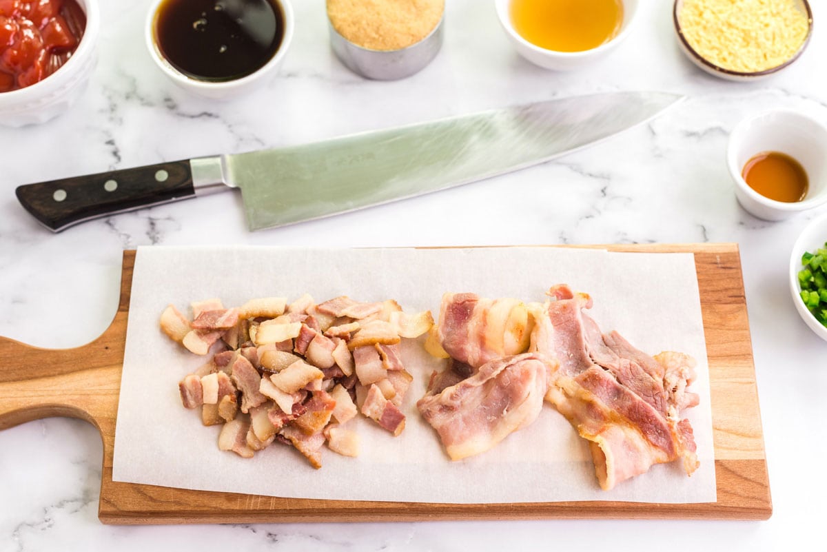 partially cooked bacon on a cutting board