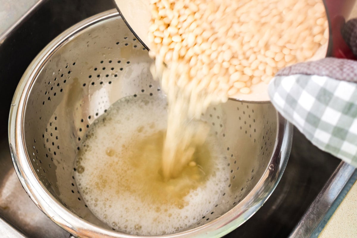 draining beans into a collander