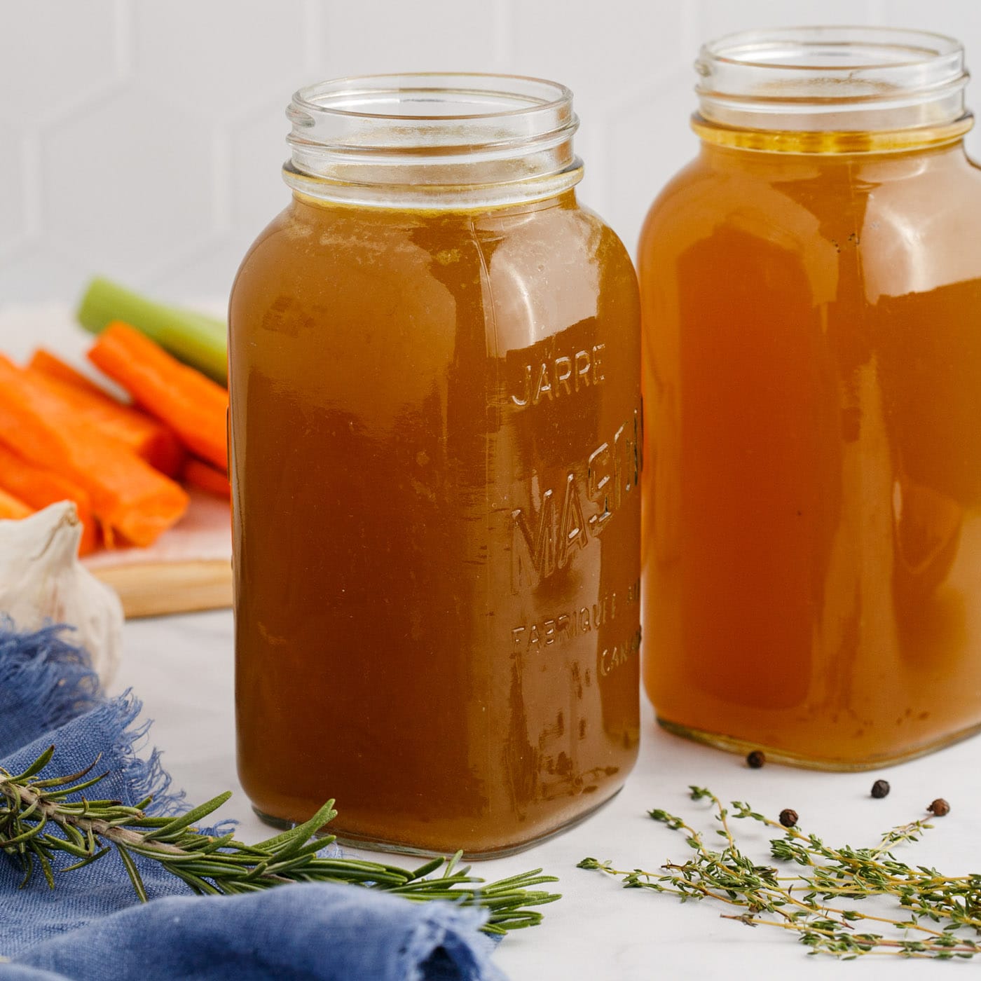 Close up photo of two jars of Homemade Chicken Stock