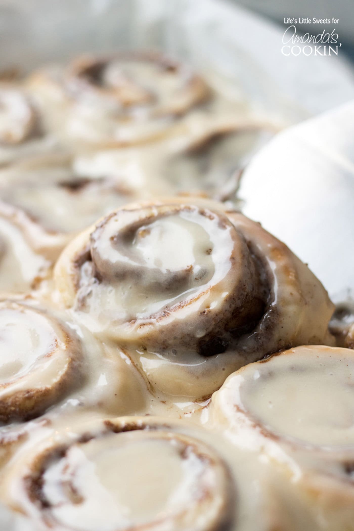 Homemade Cinnamon Roll being lifted out of the pan