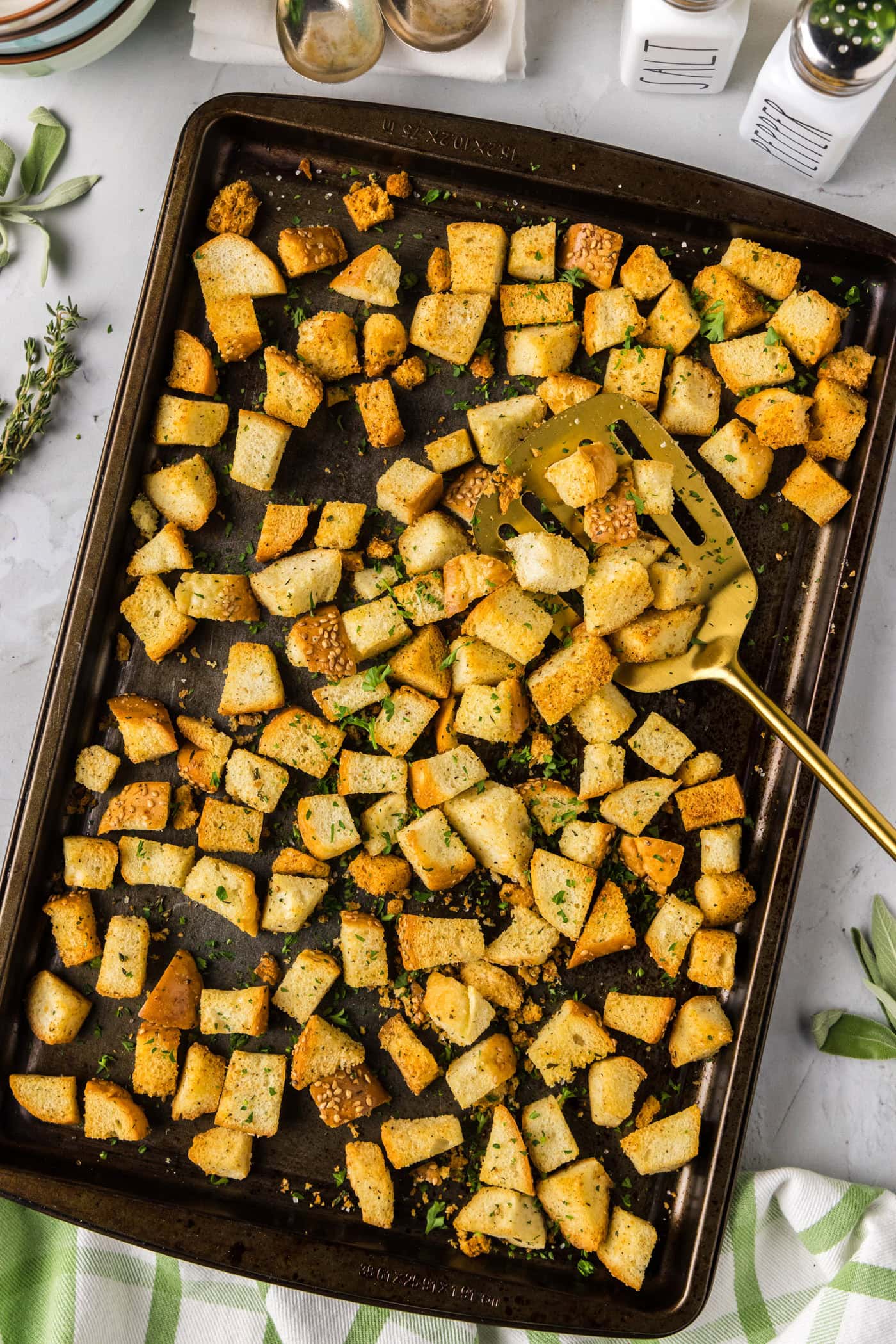 Homemade Croutons on a baking sheet with a spatula