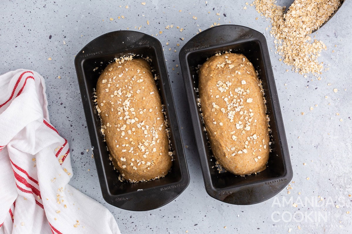 two loaf pans with bread dough