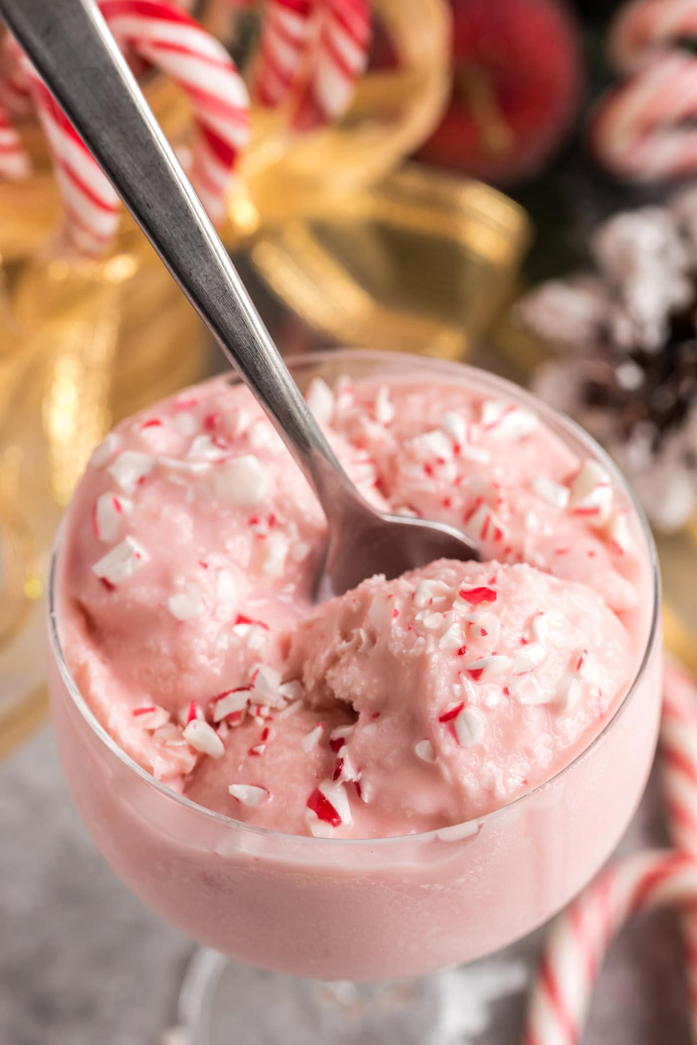 Homemade Peppermint Ice Cream in a sundae cup with a spoon in it