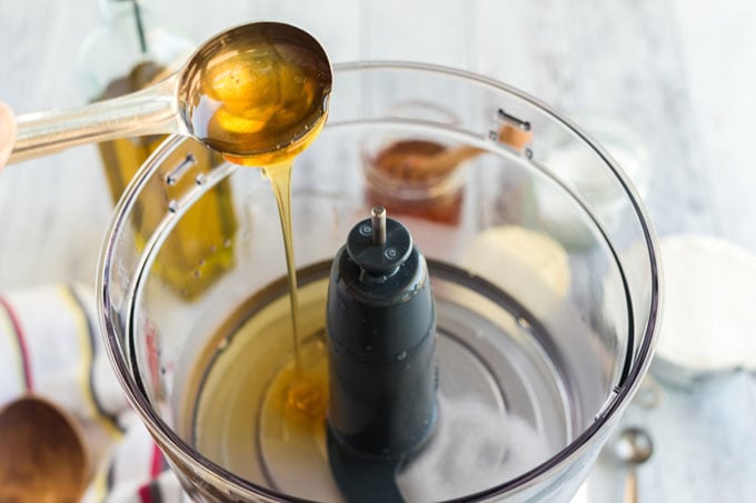 adding honey to food processor