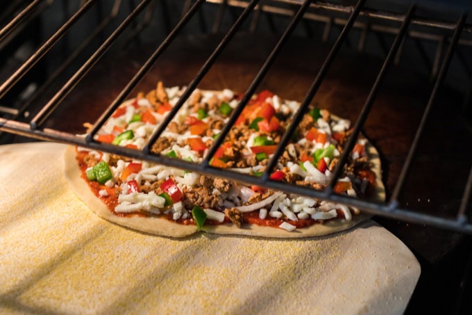 sliding pizza off the peel into the oven