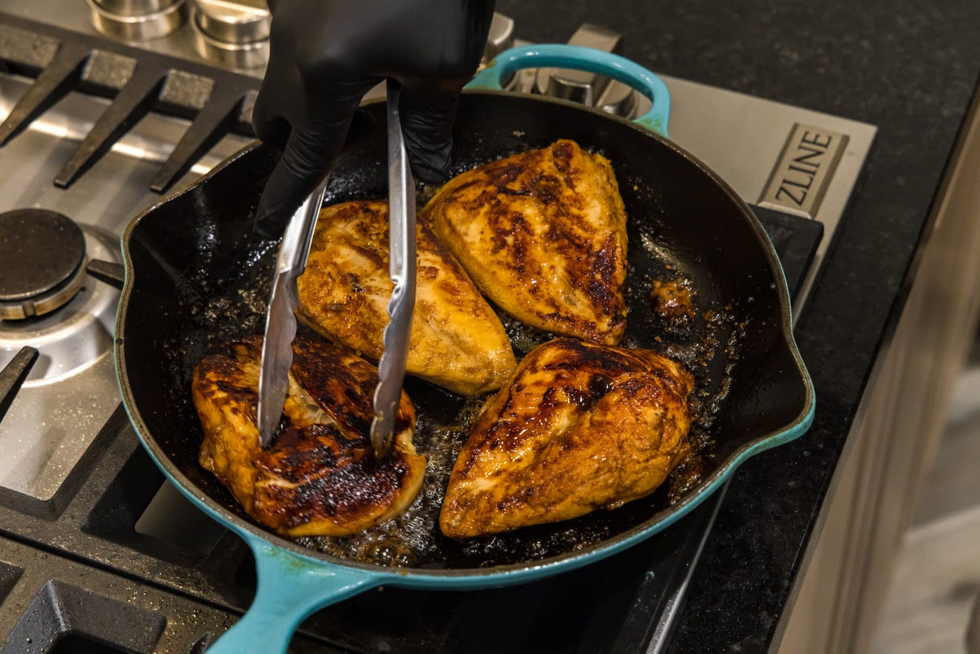 searing chicken breasts in a skillet