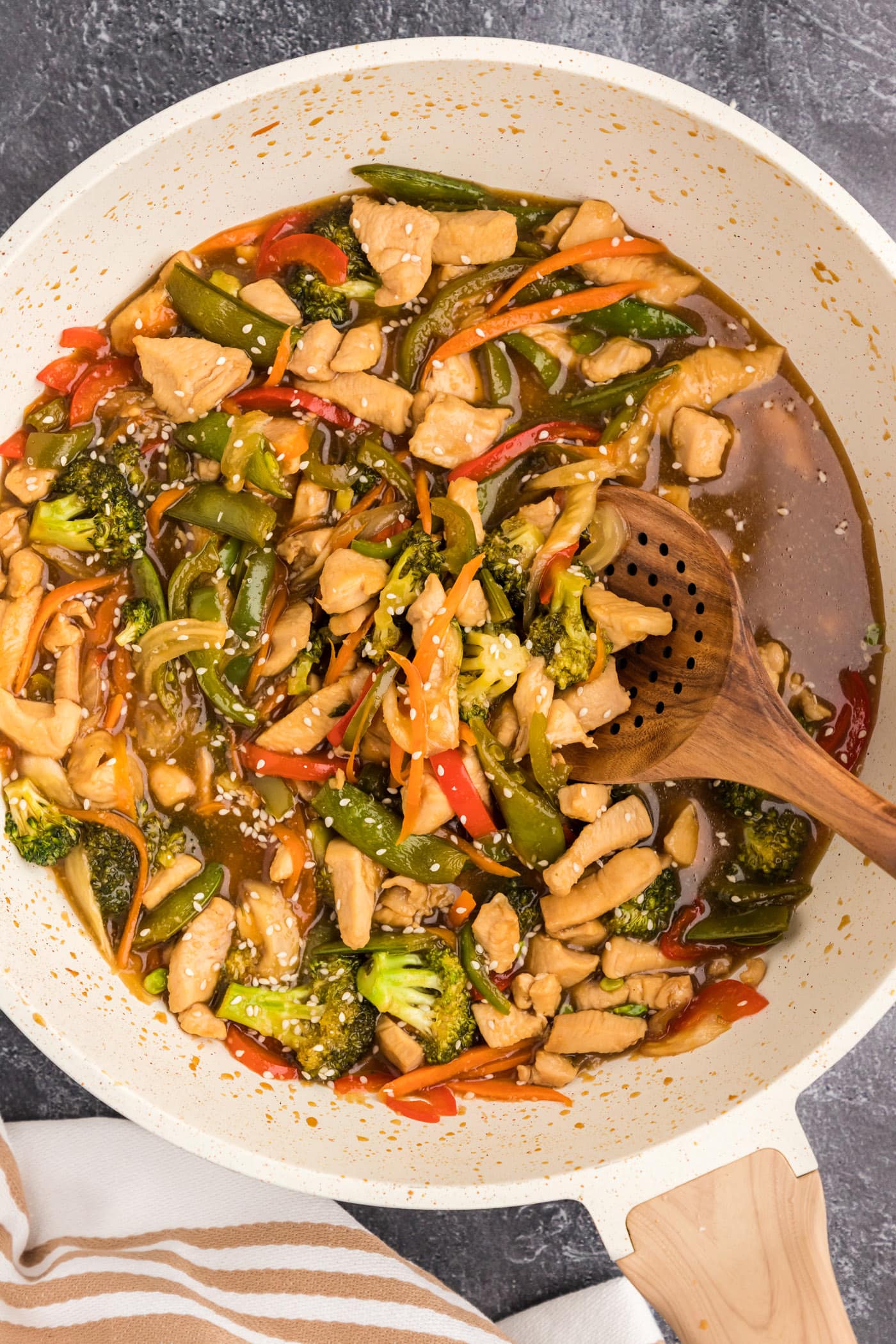 Skillet of Honey Garlic Chicken Stir Fry with a spoon in it