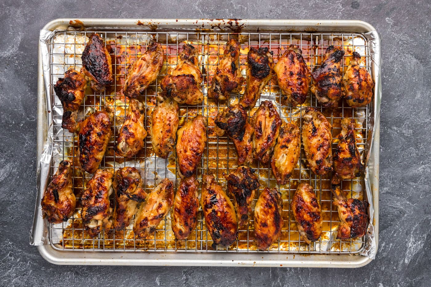 honey garlic coated wings on a baking sheet