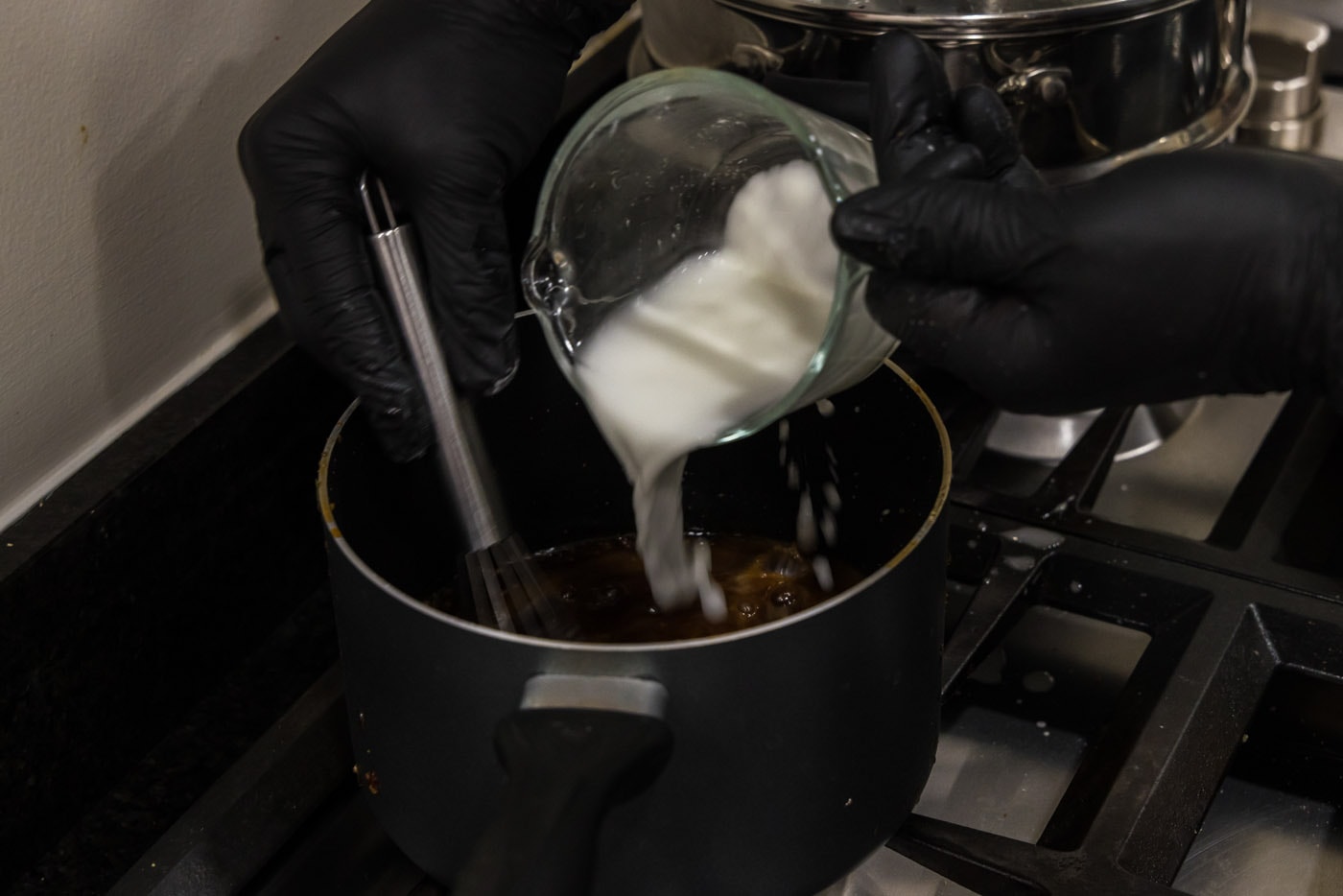 pouring cornstarch slurry into honey glaze for salmon