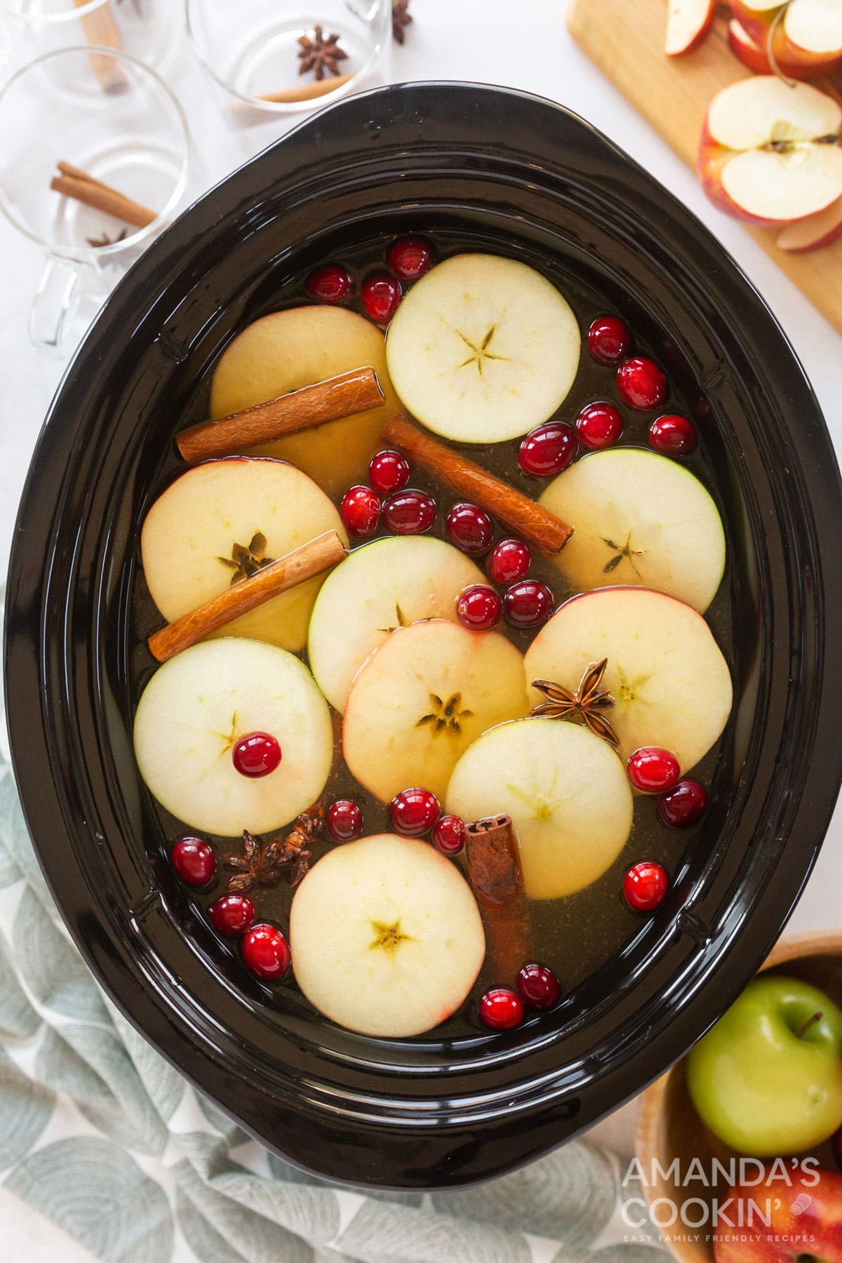 hot apple cider with garnishes in a crockpot