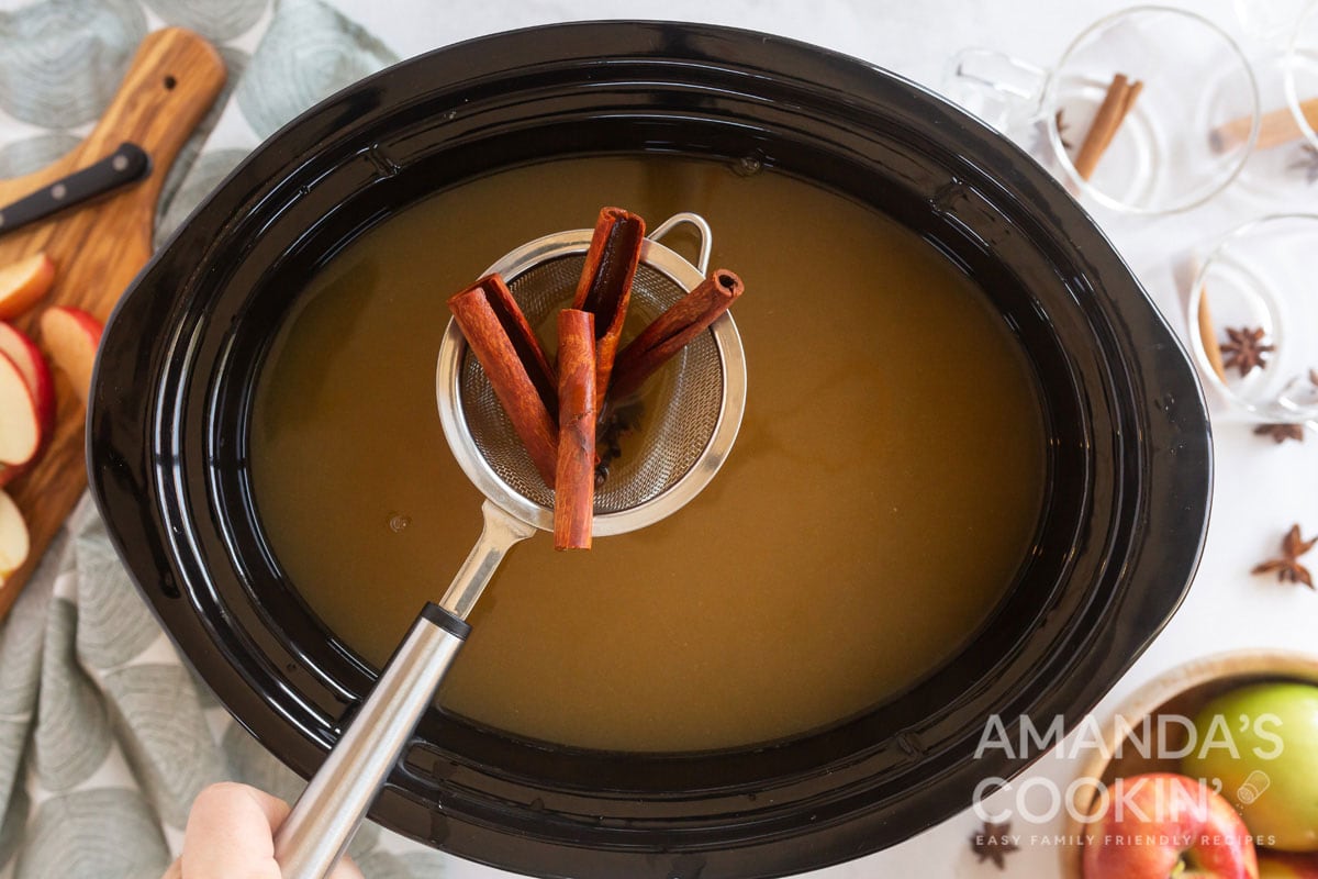 strainer with cinnamon sticks