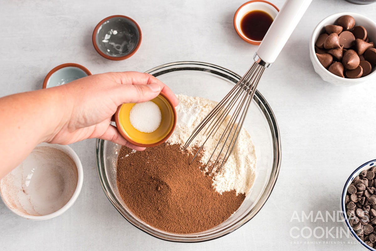adding dry ingredients to bowl