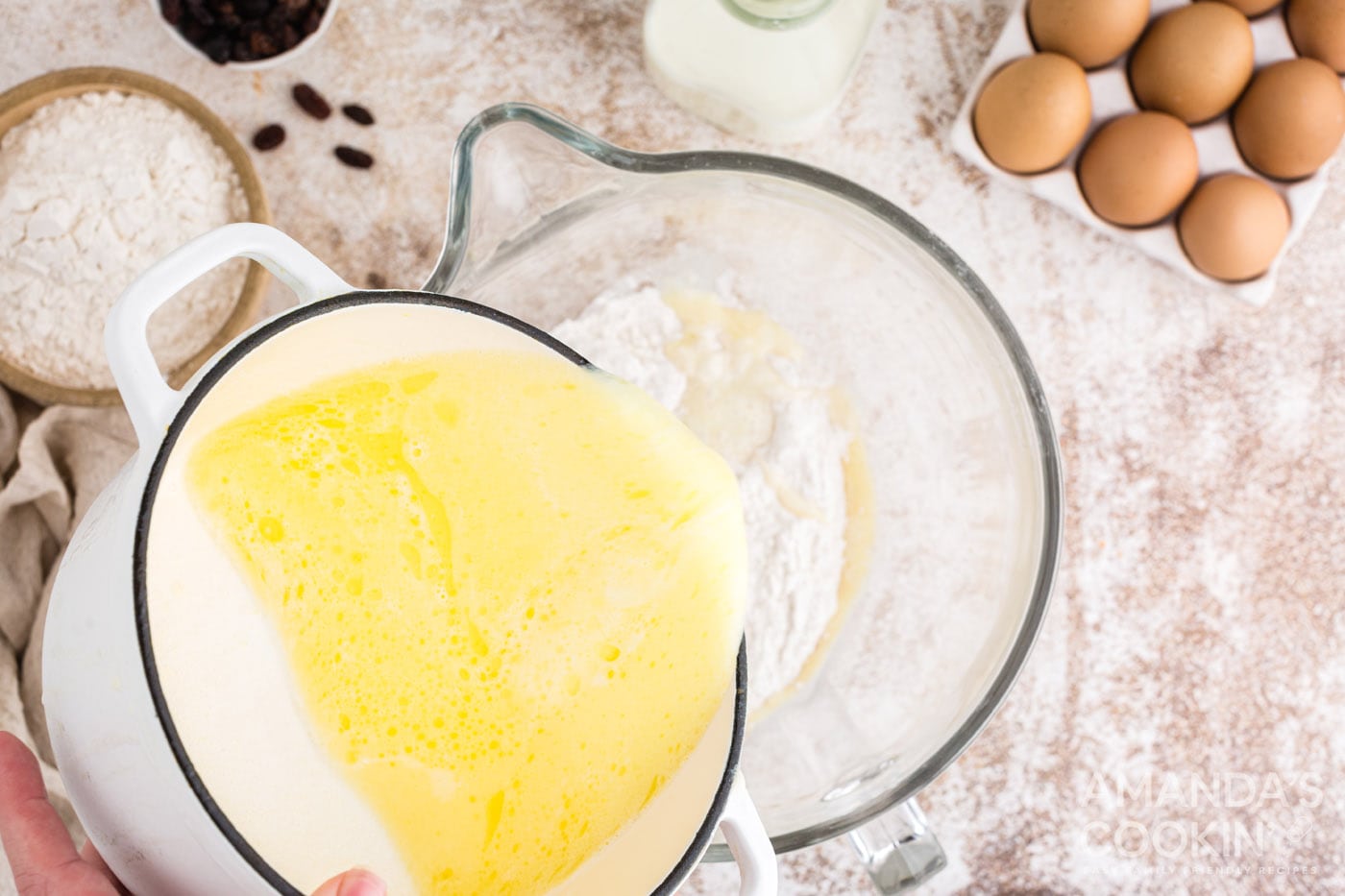 adding wet ingredients into dry ingredients in mixer bowl