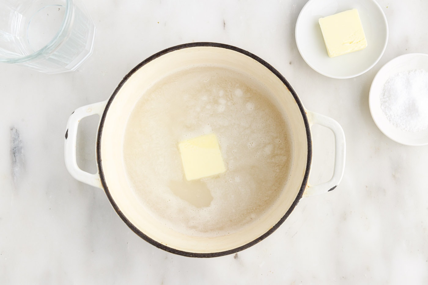 butter added to rice and water in a saucepan