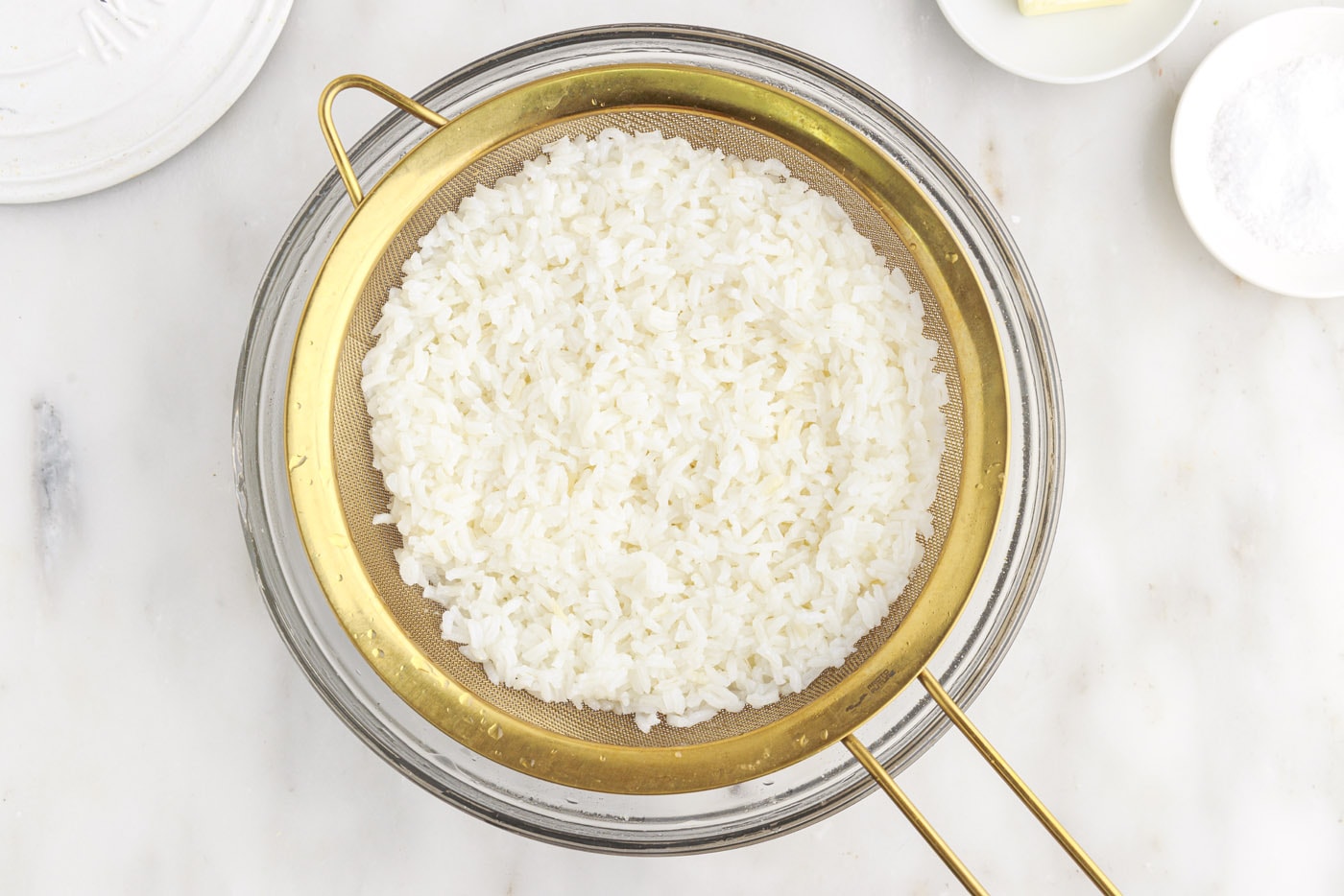 rice draining in a sieve