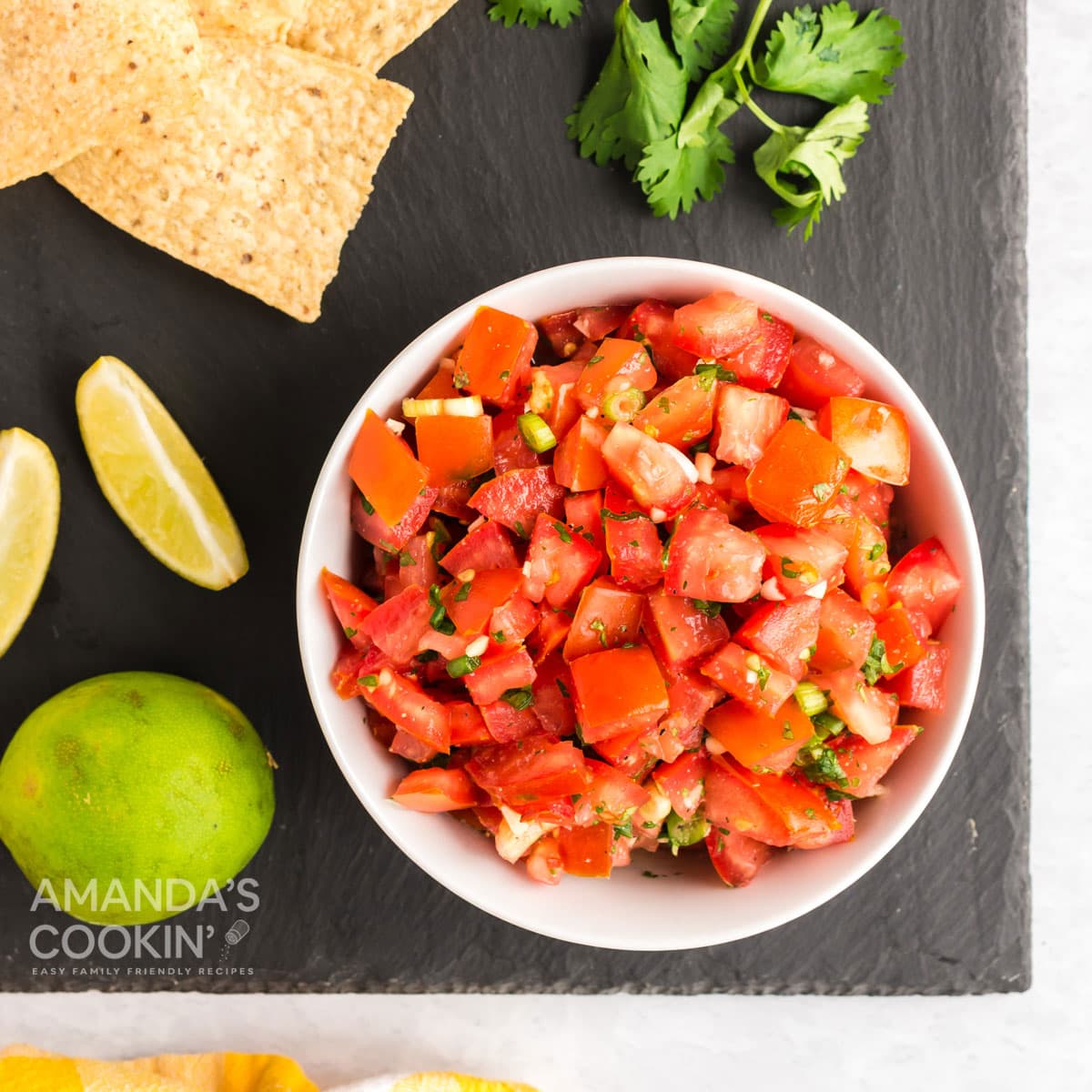bowl of salsa fresca on a black board