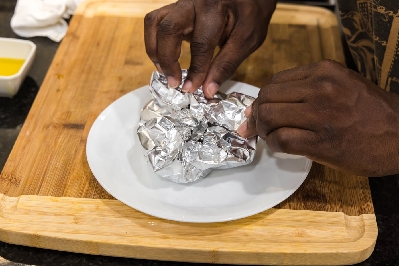 closing aluminum foil around garlic bulbs
