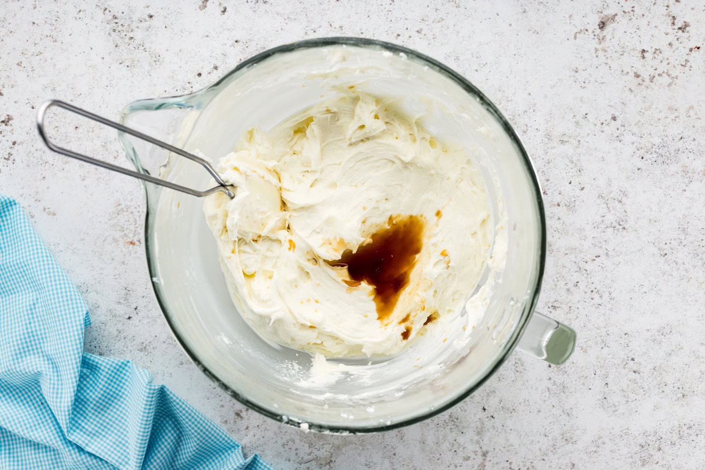 Vanilla and salt added to bowl of cream cheese frosting