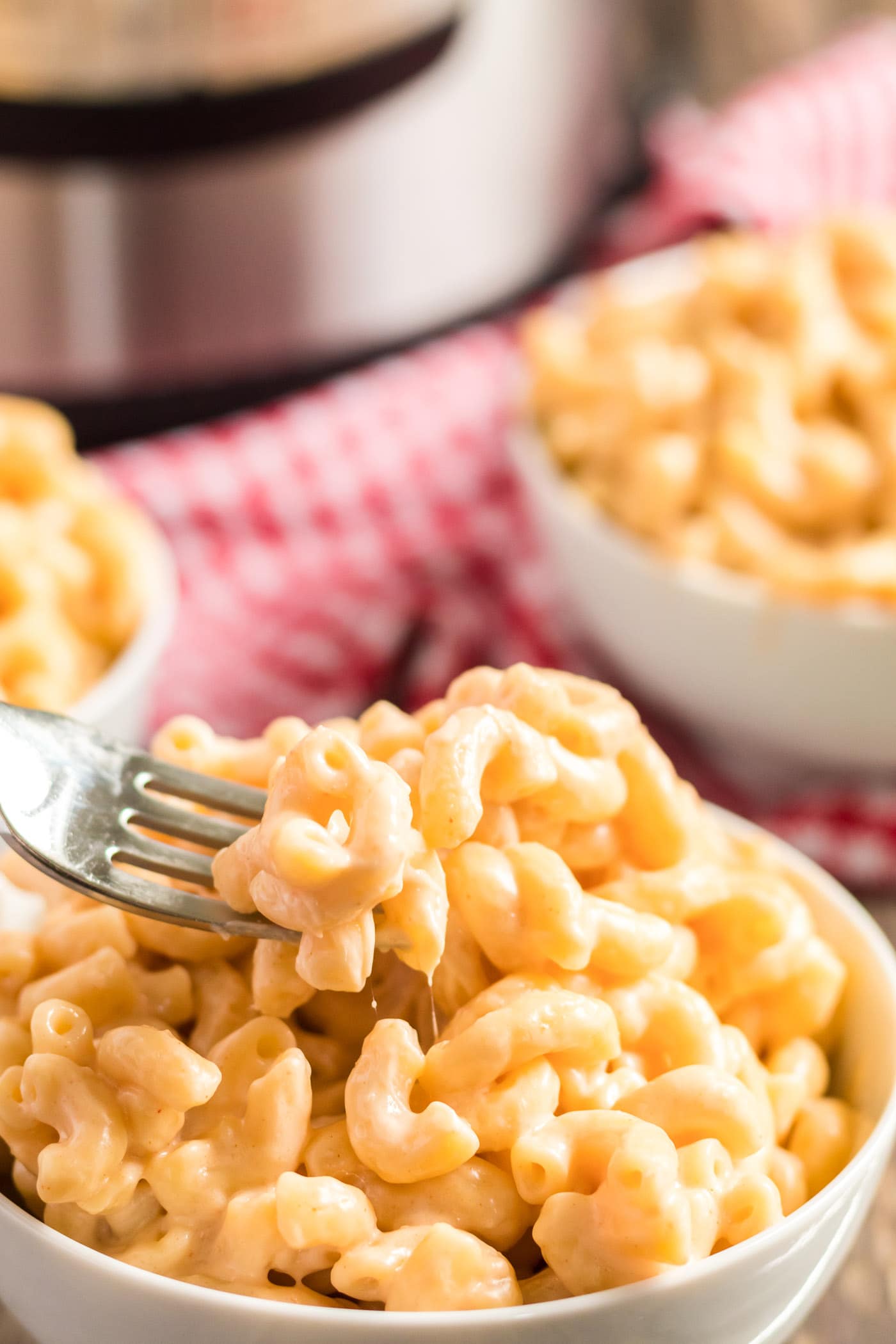 Fork in a bowl of Instant Pot Mac and Cheese
