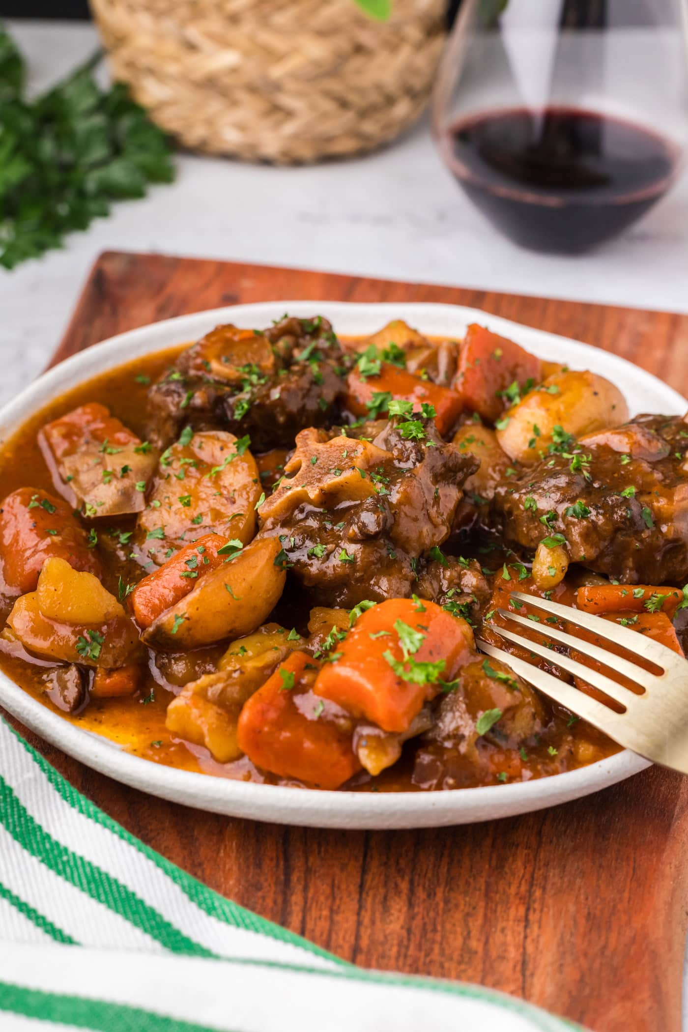 Close up photo of a plate of Instant Pot Oxtail with a fork on it