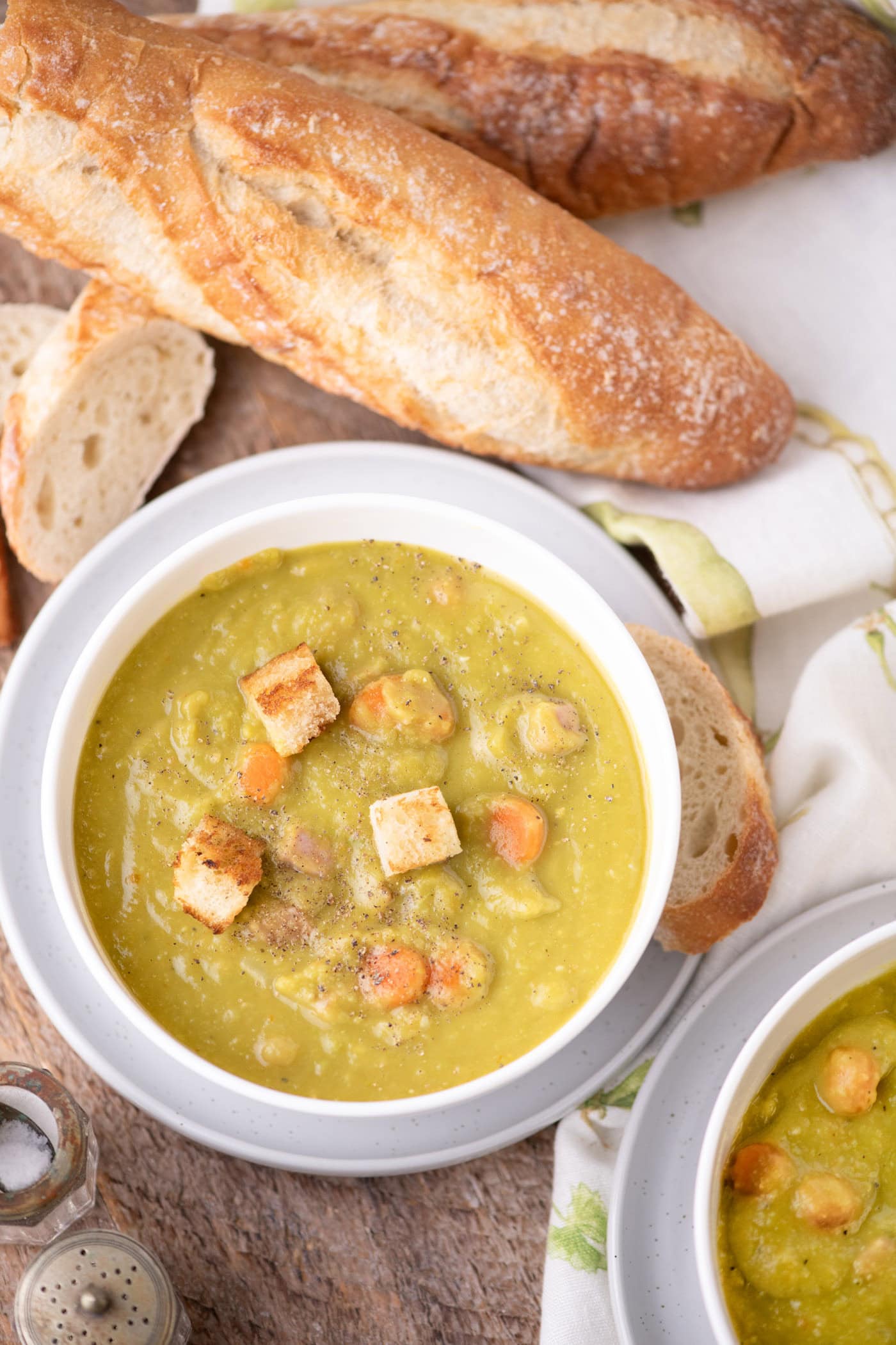 Bowl of Instant Pot Split Pea Soup with bread on the side