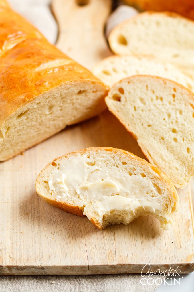 slice of Italian bread with butter and a bite out of it