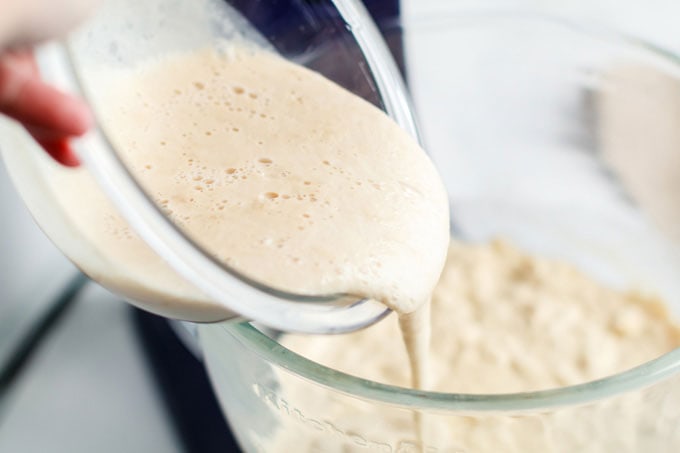 adding yeast mixture to bowl