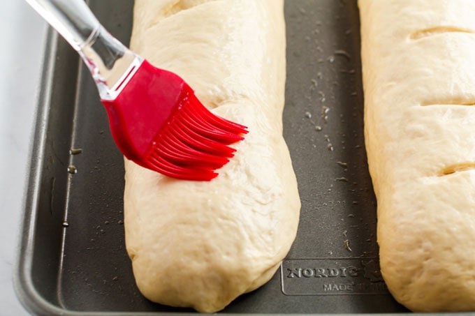 brushing top of bread loaves