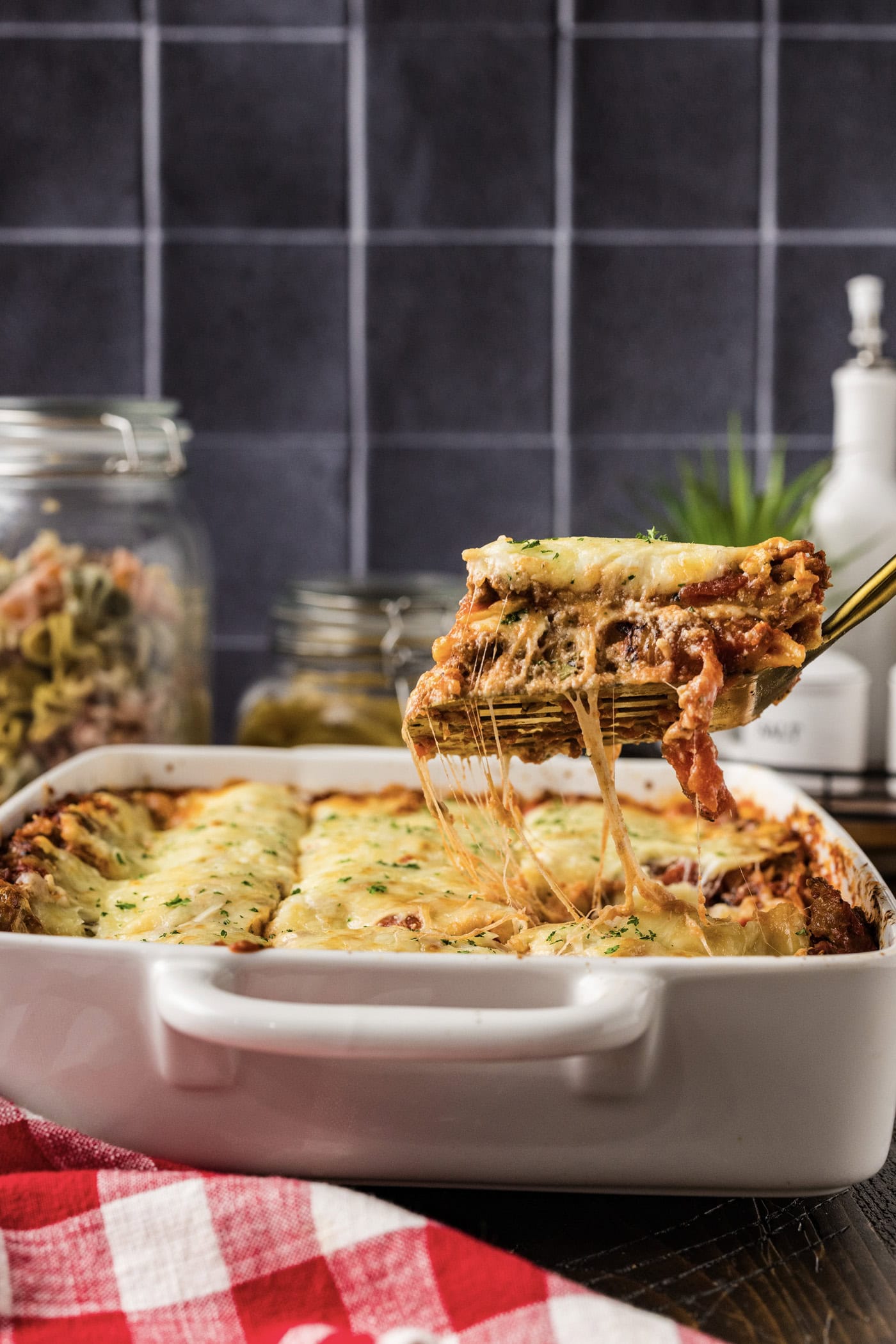 Spatula lifting up a piece of Italian Lasagna from the pan