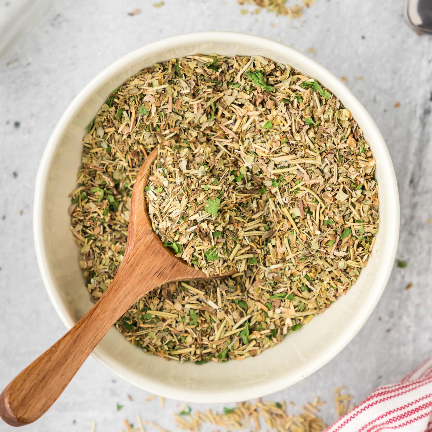 Bowl of Italian Seasoning with a spoon in it