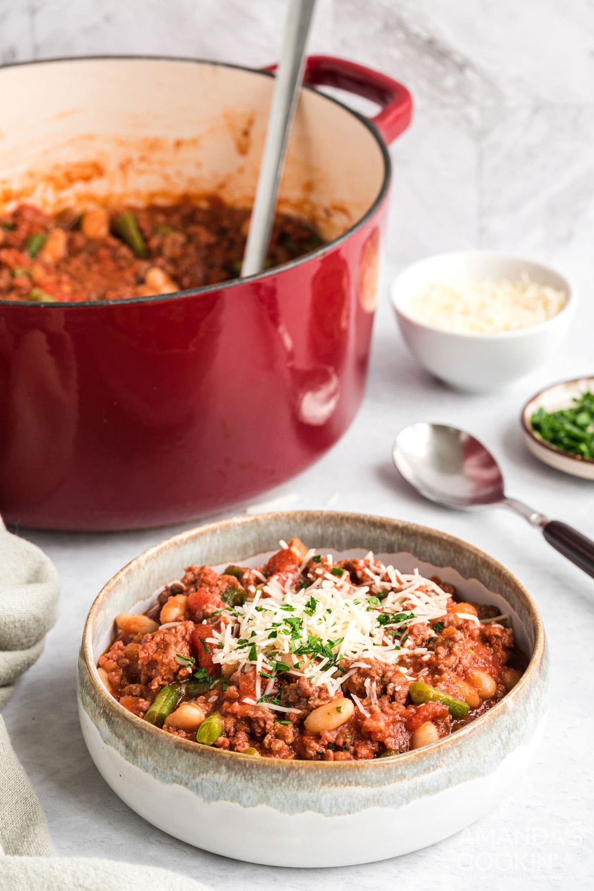 bowl of hamburger stew with a pan in the background
