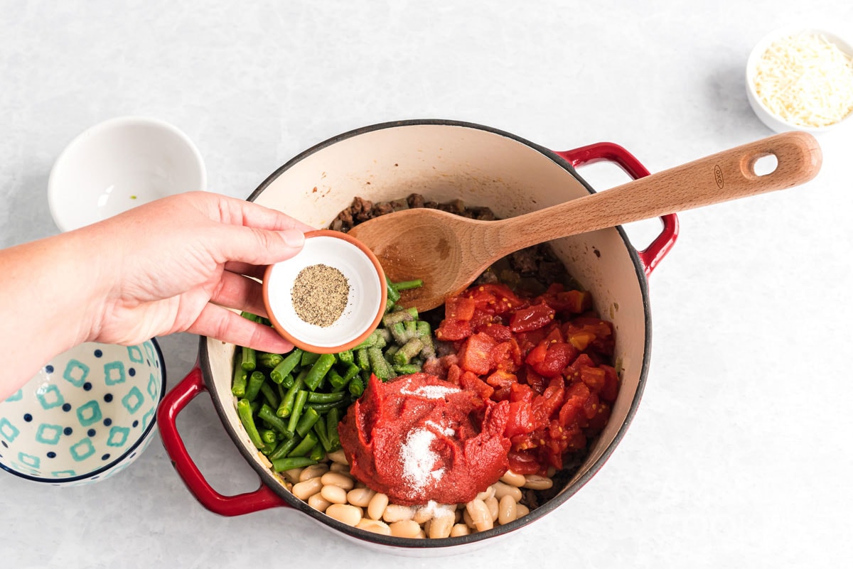 adding seasoning to pot
