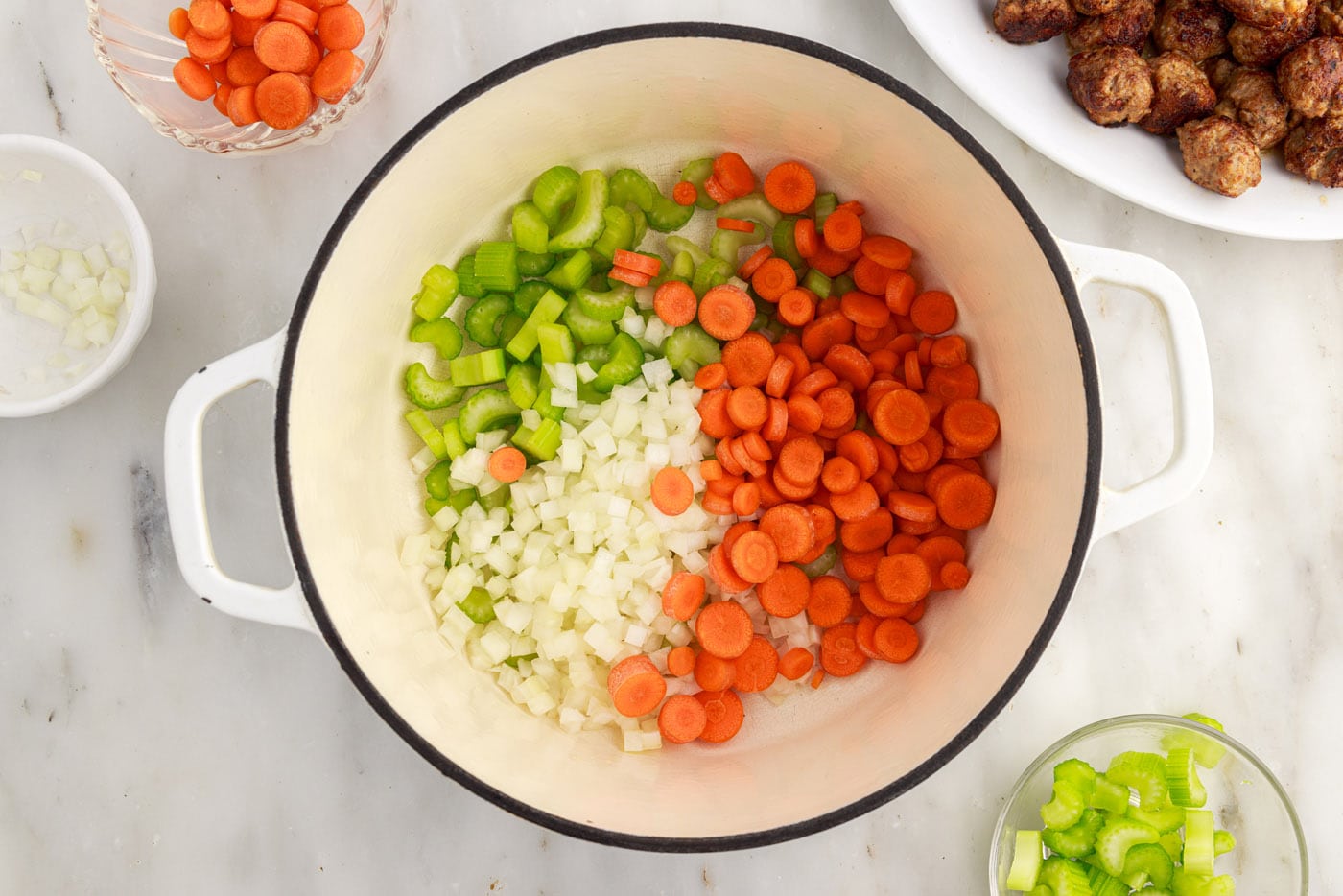 carrots, onion, and celery in a soup pot
