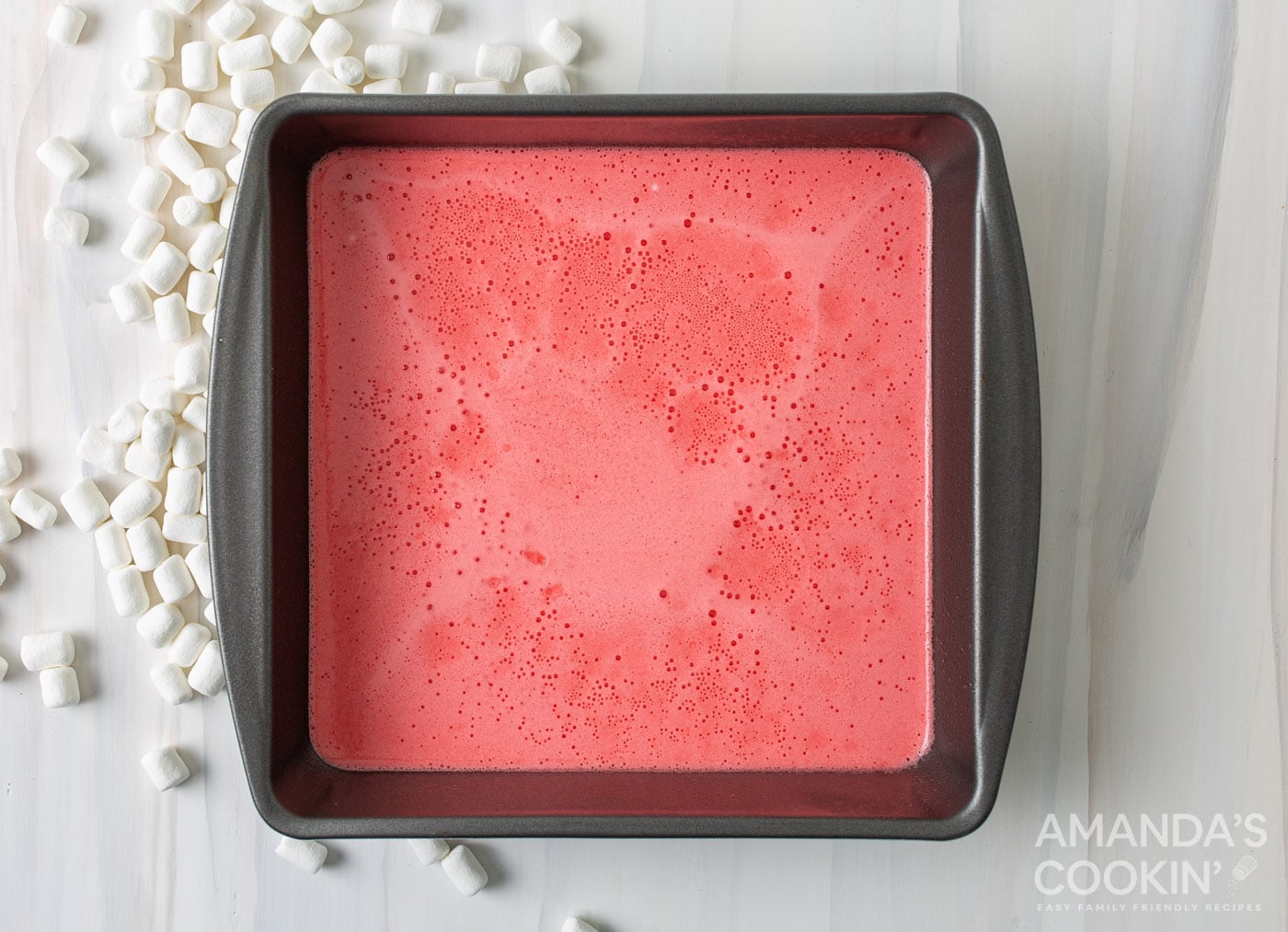 red jello and marshmallow mixture in a pan