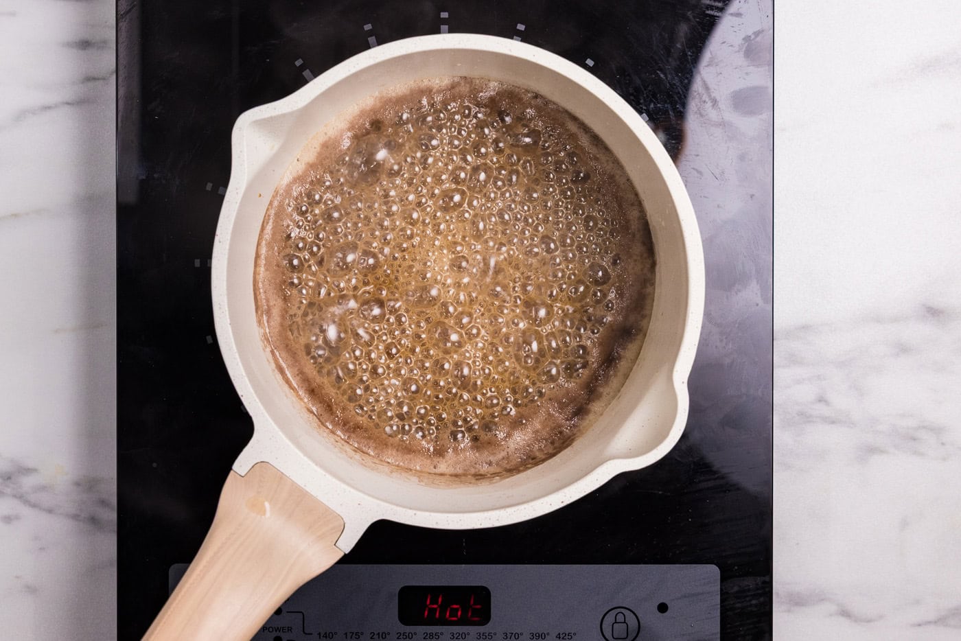 brown sugar, maple syrup, and bourbon sauce in a saucepan bubbling