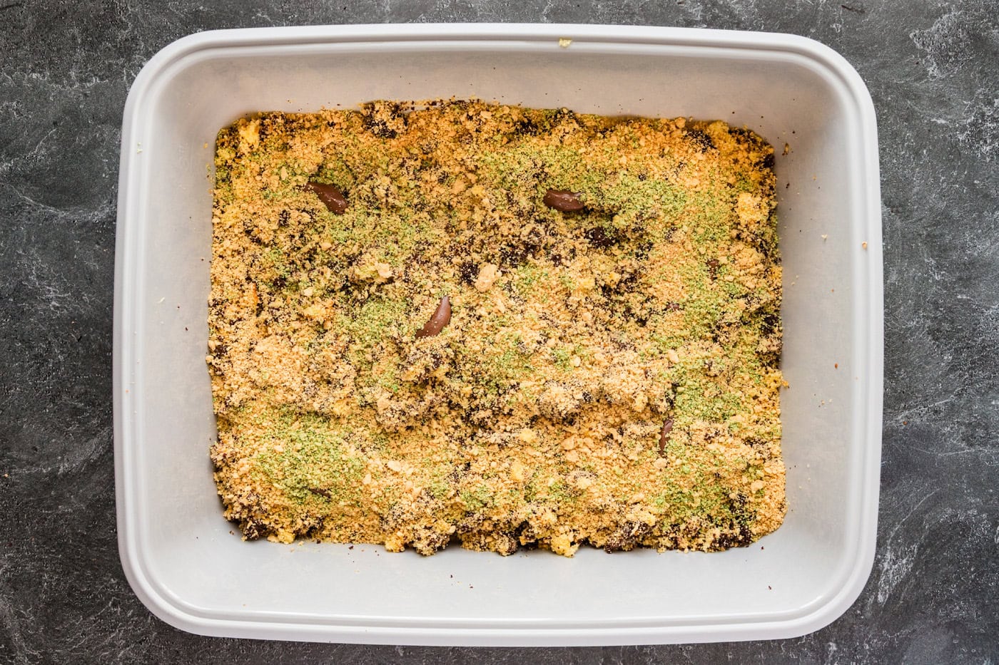 green tined cookie crumbles on top of kitty litter cake
