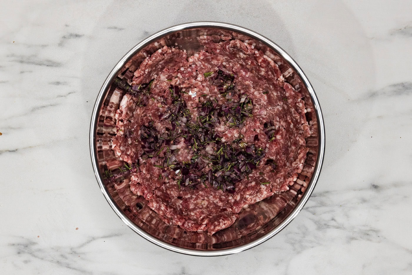 ground lamb with seasonings in a bowl