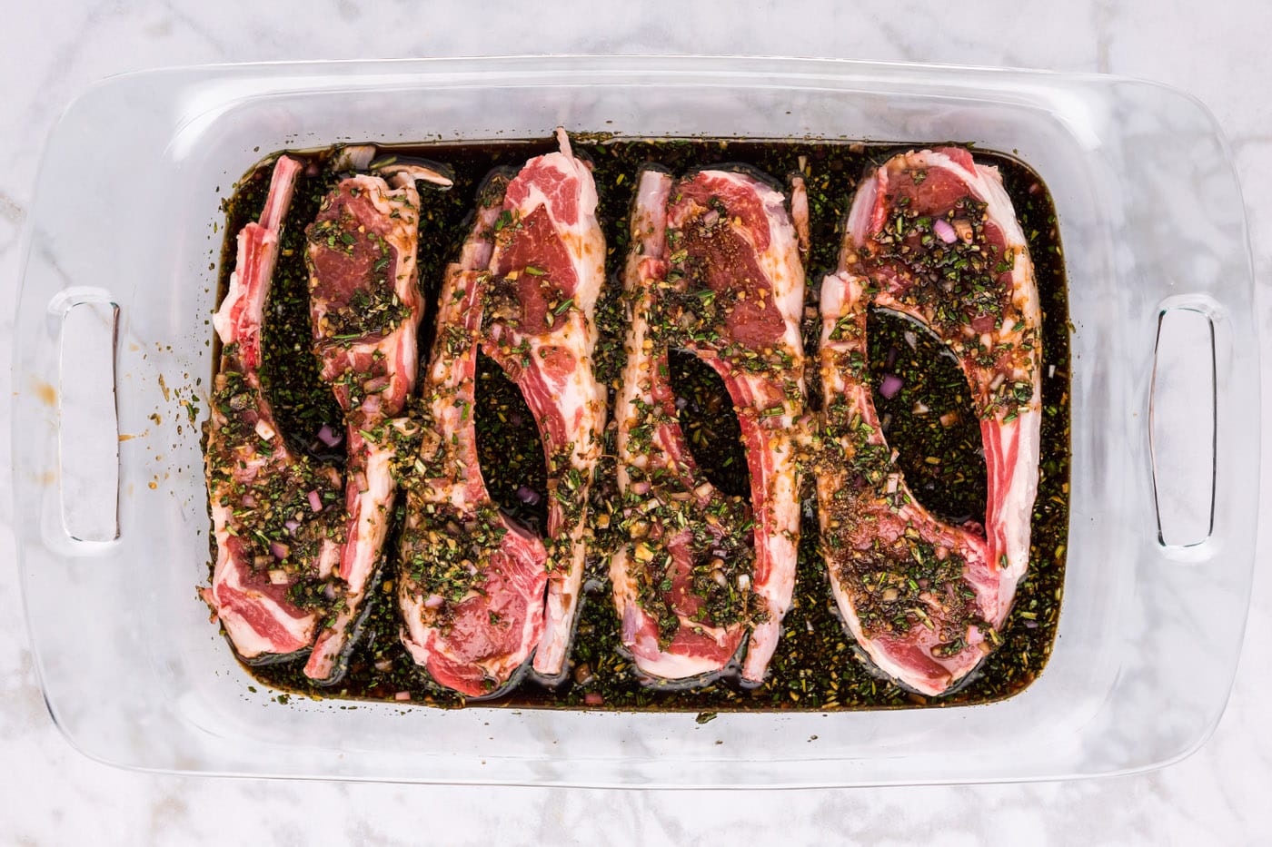 lamb chops sitting in marinade