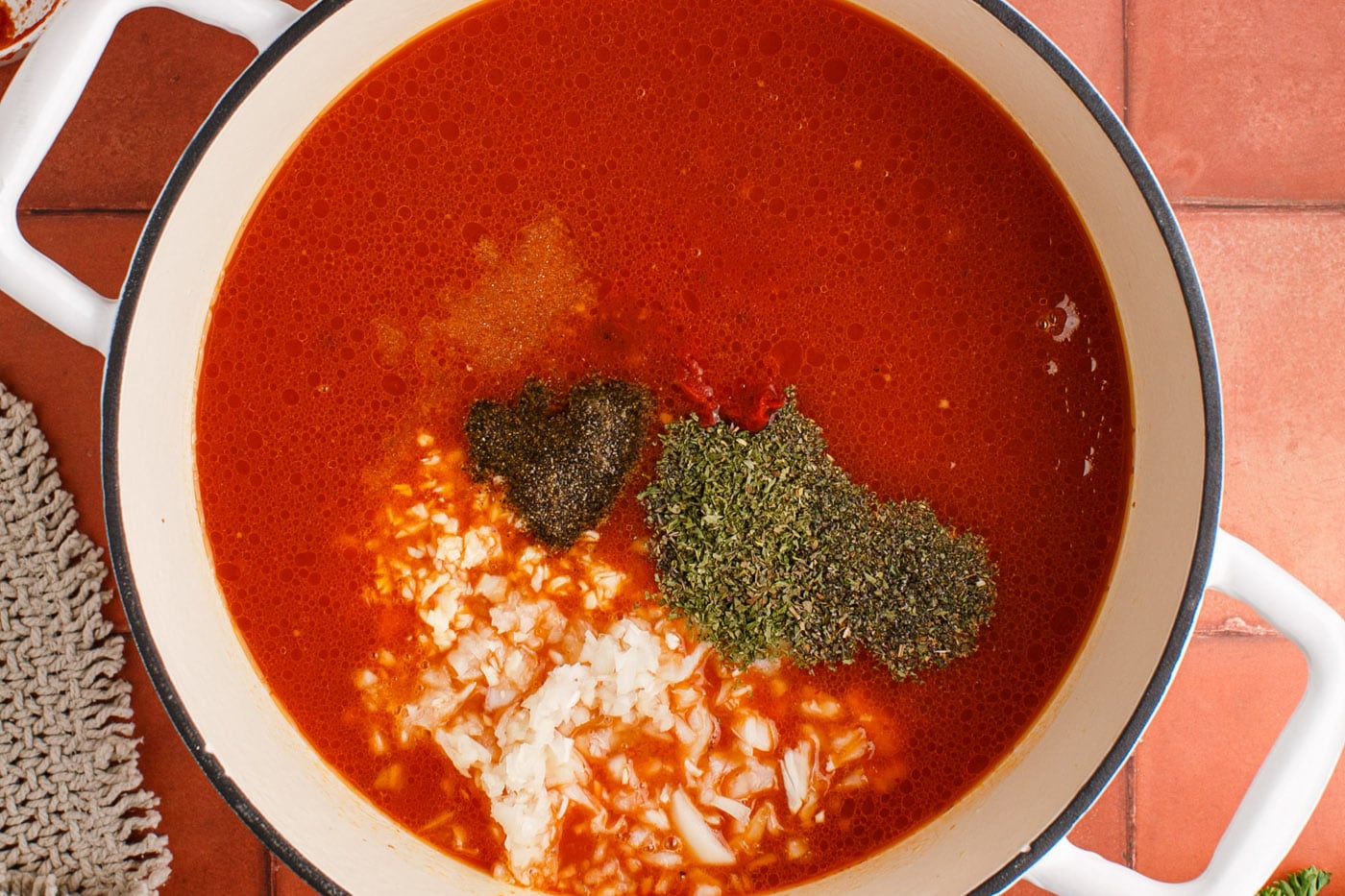 Italian herbs and seasonings added to marinara with beef and sausage
