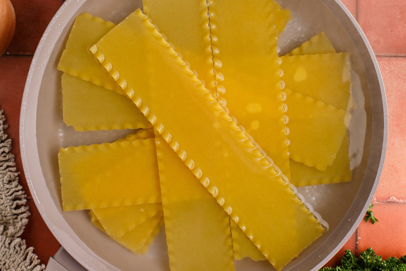 soaking lasagna noodles in a pot to soften