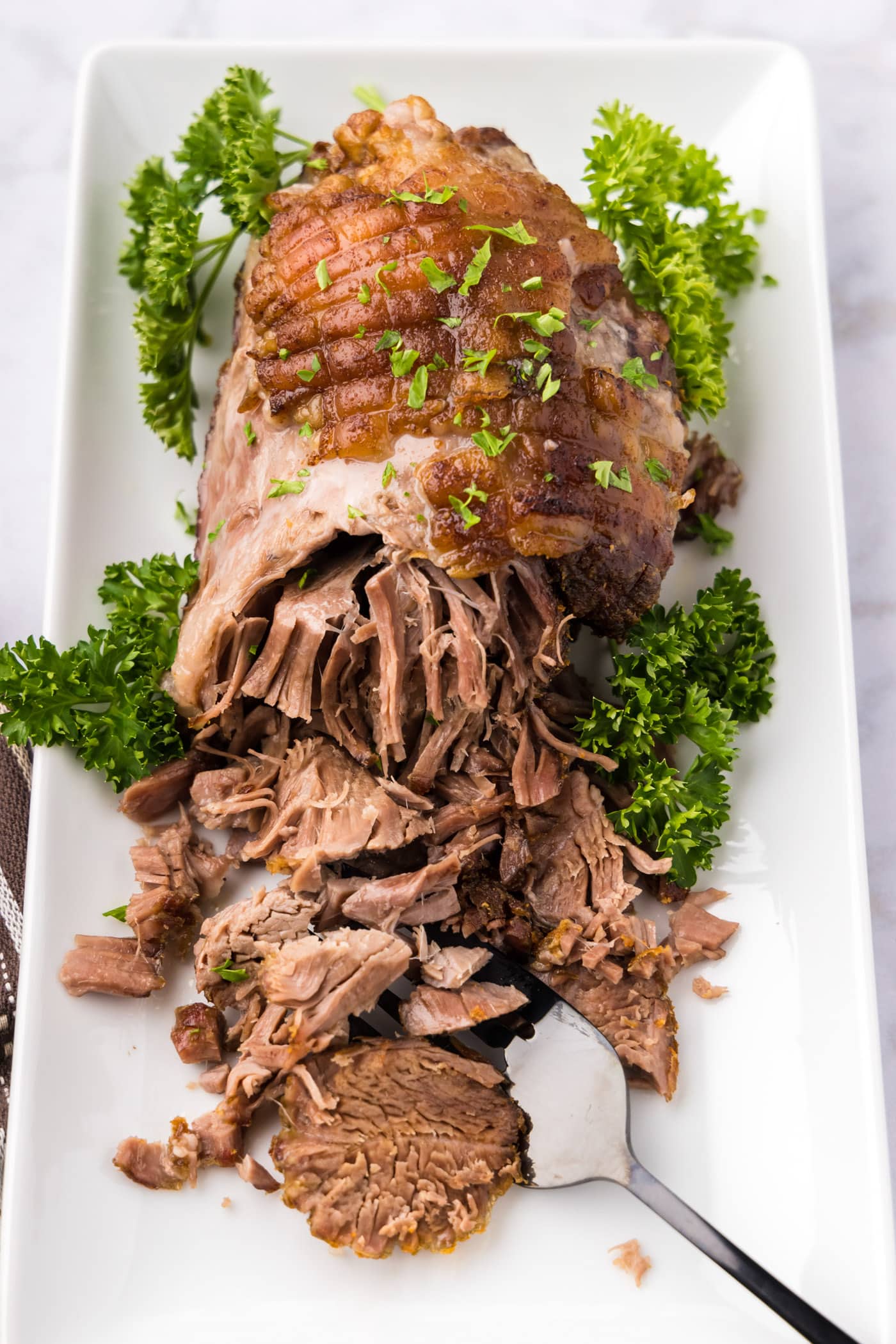 Leg of Lamb on a platter half shredded
