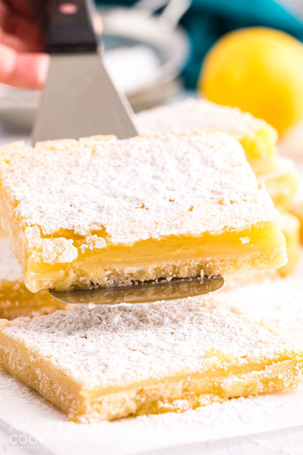 lemon bar being lifted with spatula