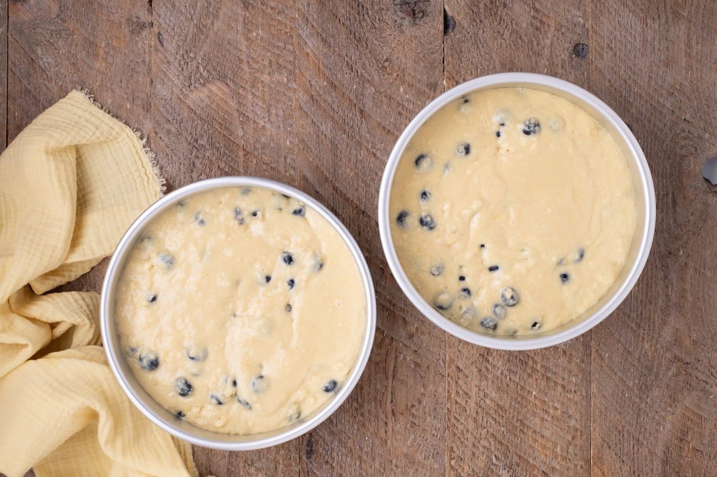 lemon blueberry cake batter in baking pans