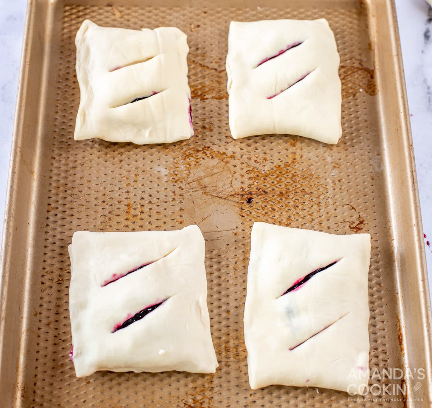 lemon blueberry hand pies on a baking sheet