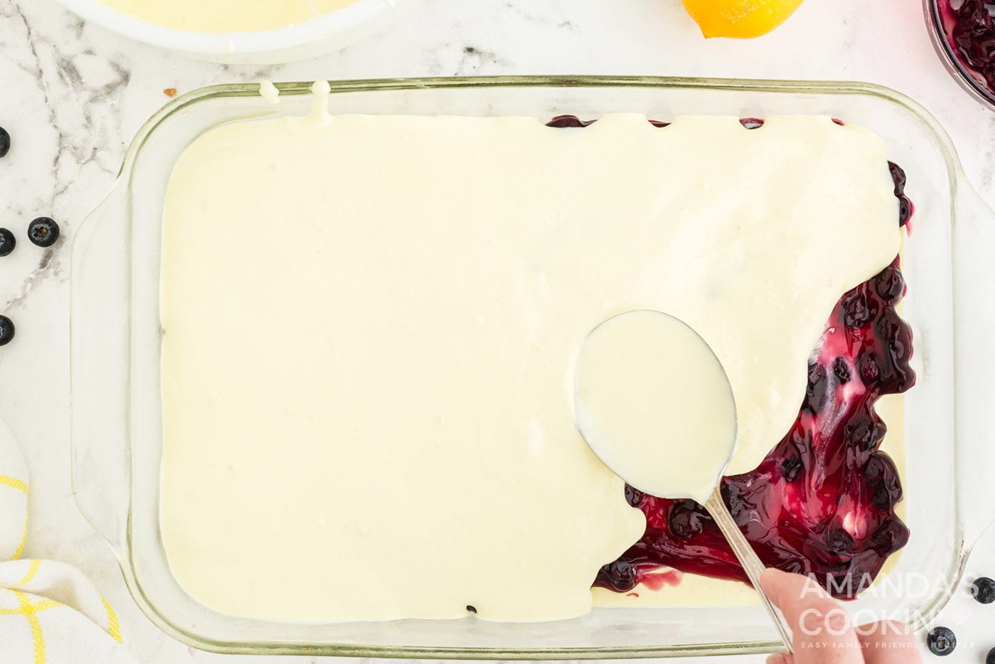 layering pudding on top of blueberry pie filling