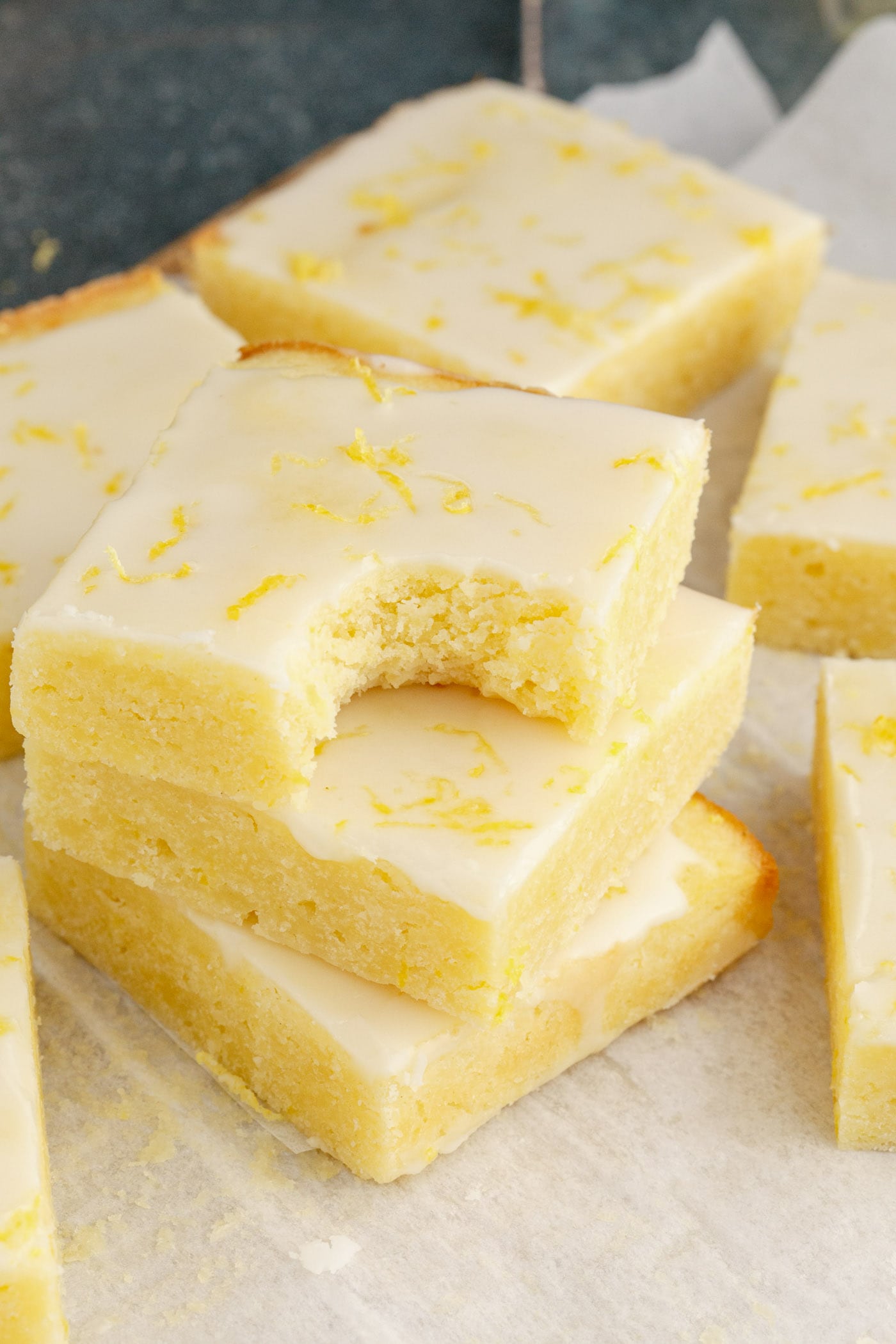 Stack of Lemon Brownies with a bite taken out of the top brownie