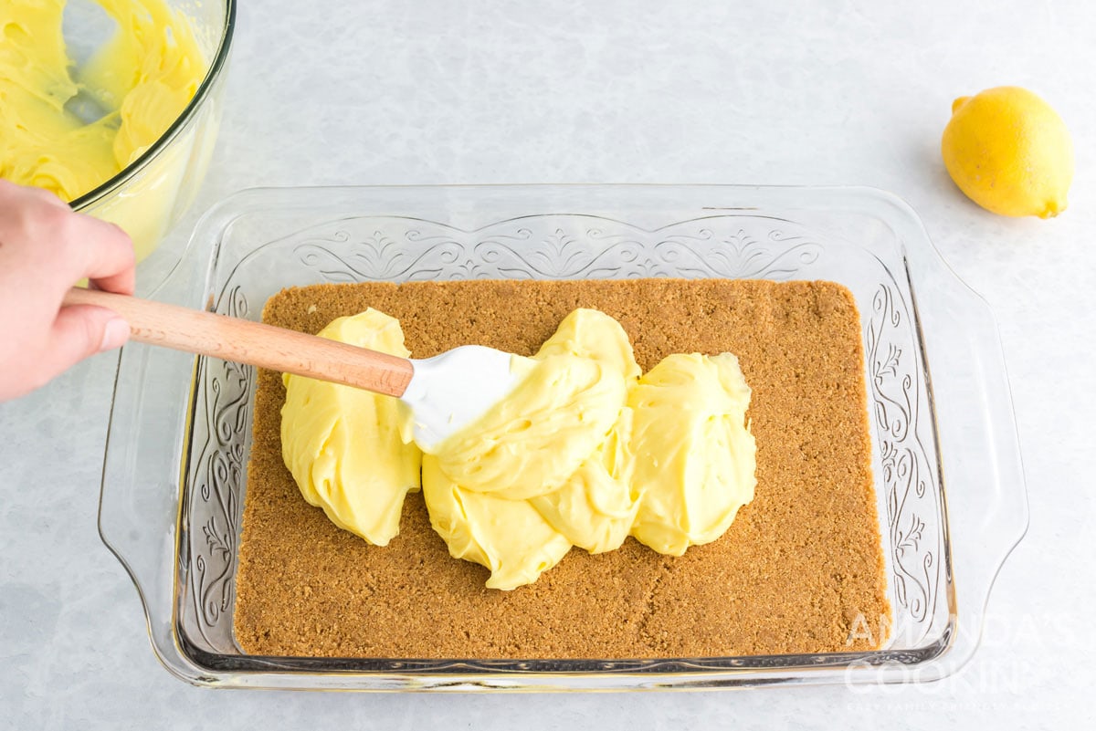 spreading pudding mixture over crust in pan