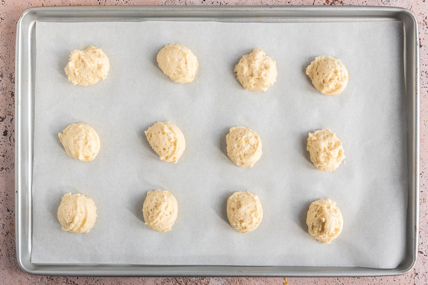 cookie dough balls on a baking sheet