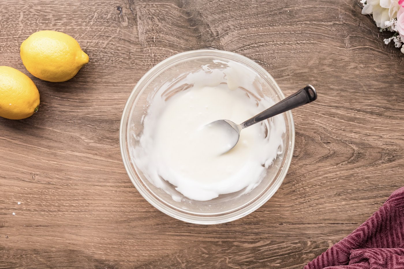 Mixed icing in a bowl with a spoon