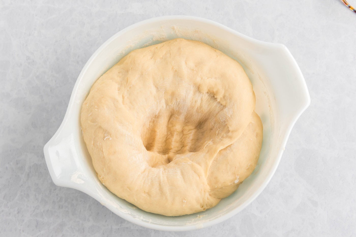 dough with a punch mark in a bowl